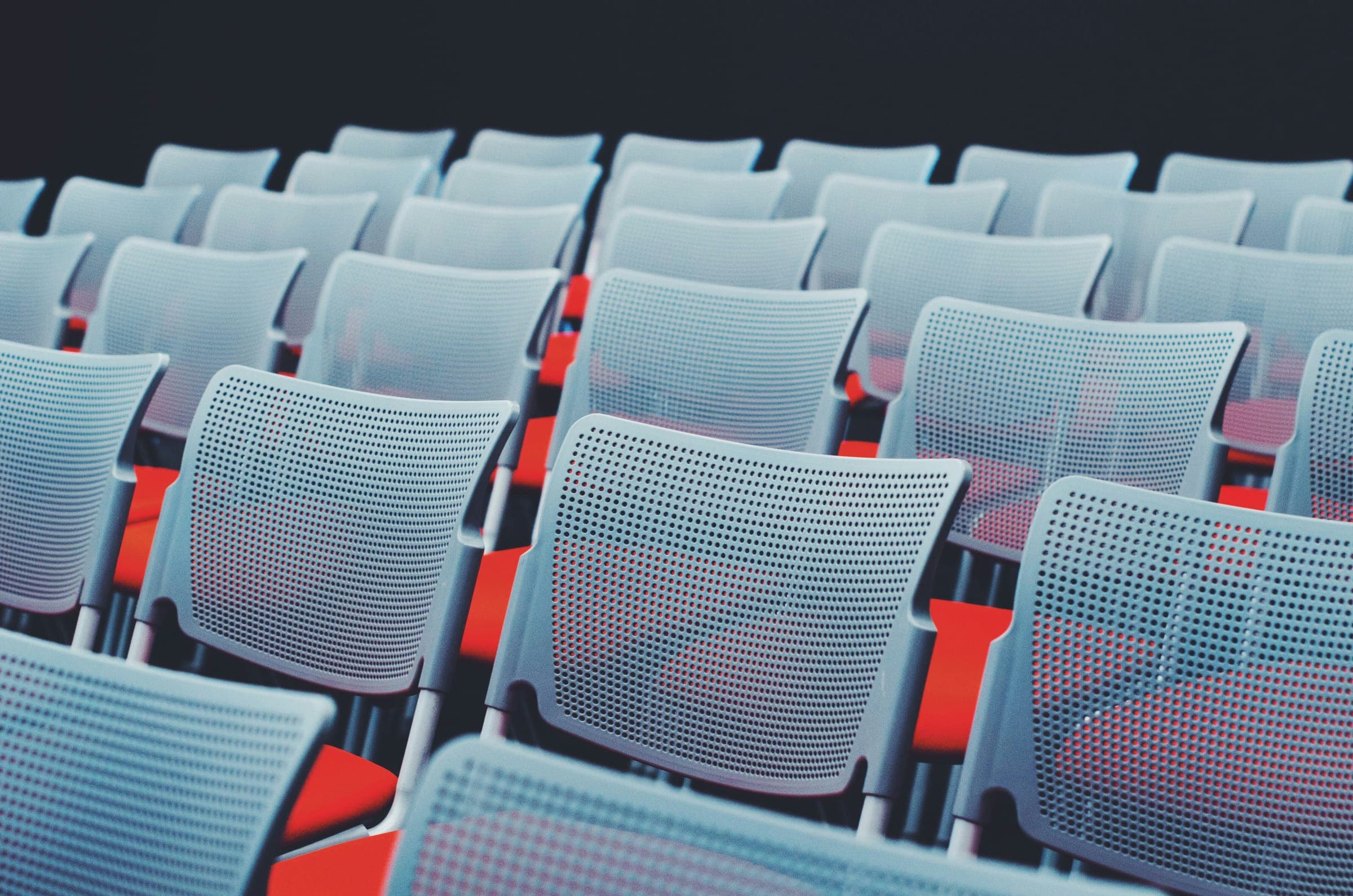 Rows of empty auditorium seats waiting for an audience